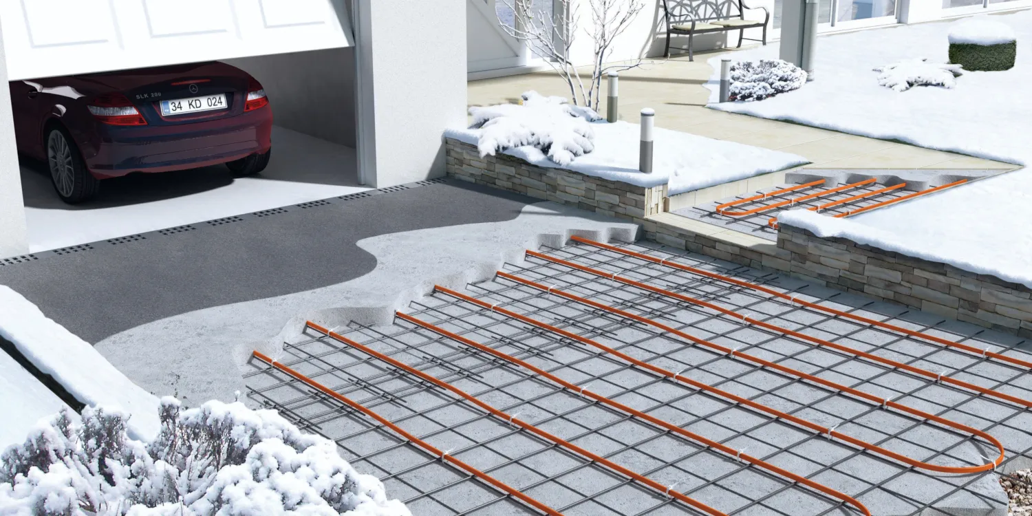 Cross-section of a driveway and path outside of a frozen domestic property showing ramp and footpath heating mats.